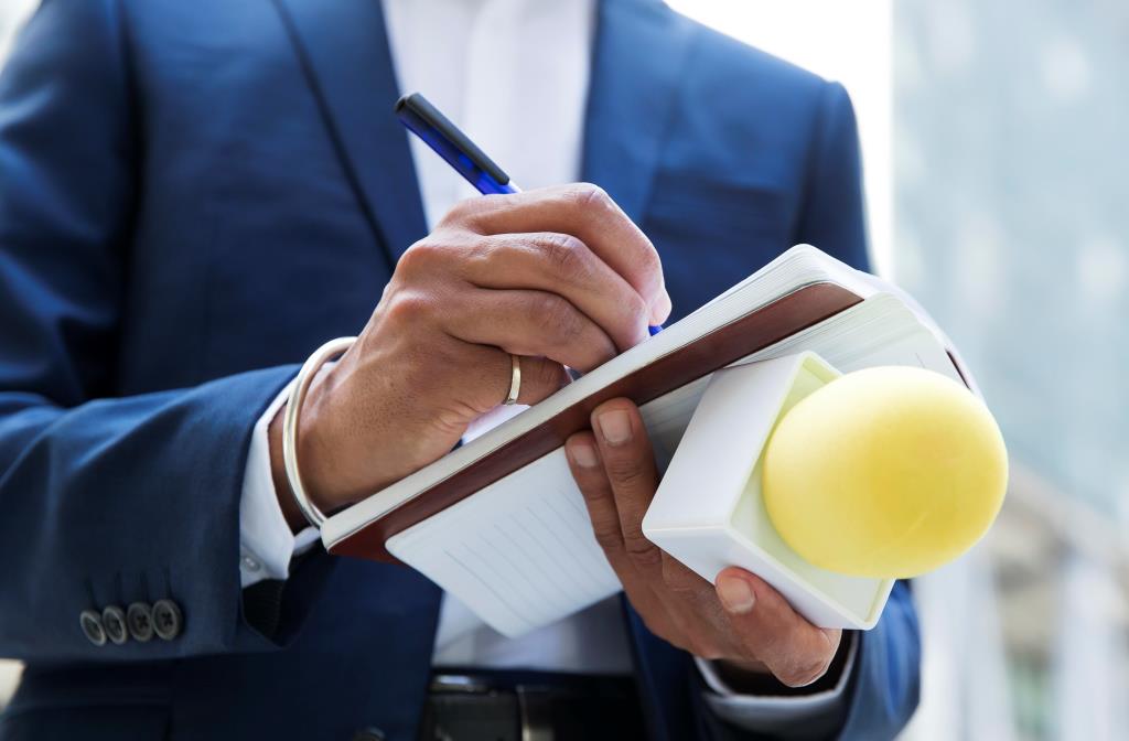 close-up-interviewee-taking-notes